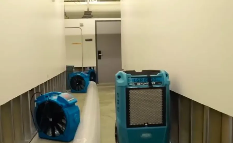 Commercial water damage restoration equipment — dehumidifiers and air movers set up in a Garland, TX commercial property