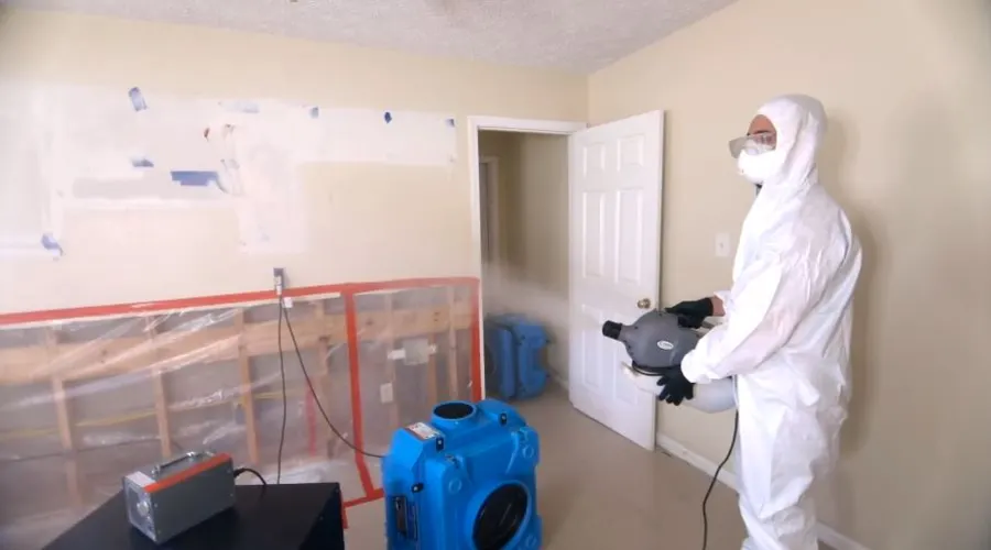 Garland Restore technician in PPE and containment gear performing mold remediation in Garland, TX