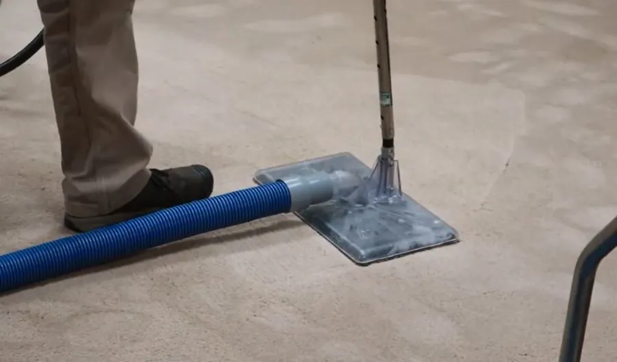 Professional carpet water extraction equipment removing trapped moisture from flooring