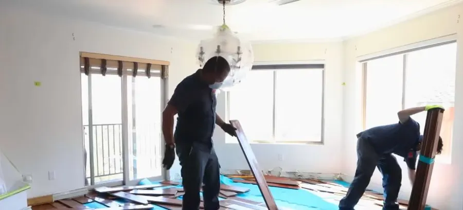 Commercial water damage restoration crew drying equipment inside an office