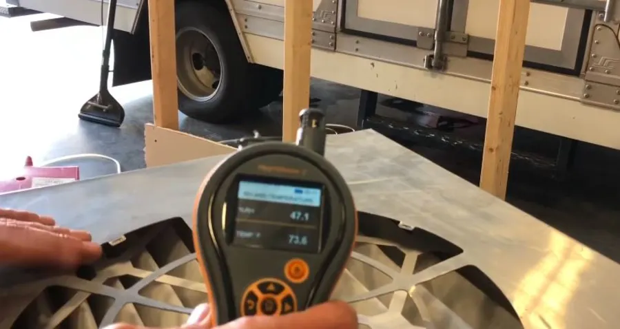 Technician checking relative humidity and temperature during water damage drying