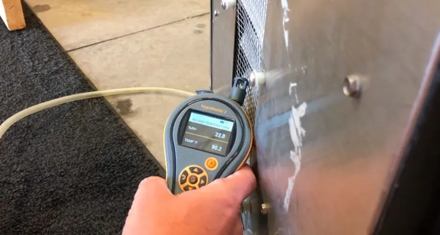 Garland Restore technician monitoring humidity and temperature during structural drying