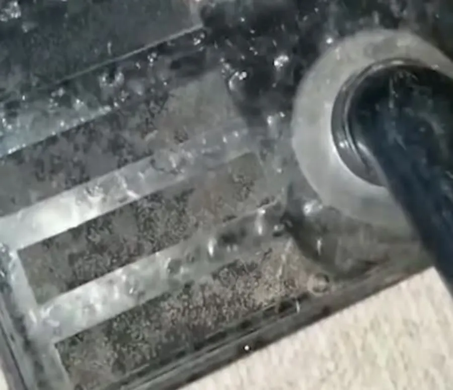 Technician performing water extraction with commercial equipment during a water damage cleanup